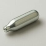a metallic, cylindrical device on a neutral background